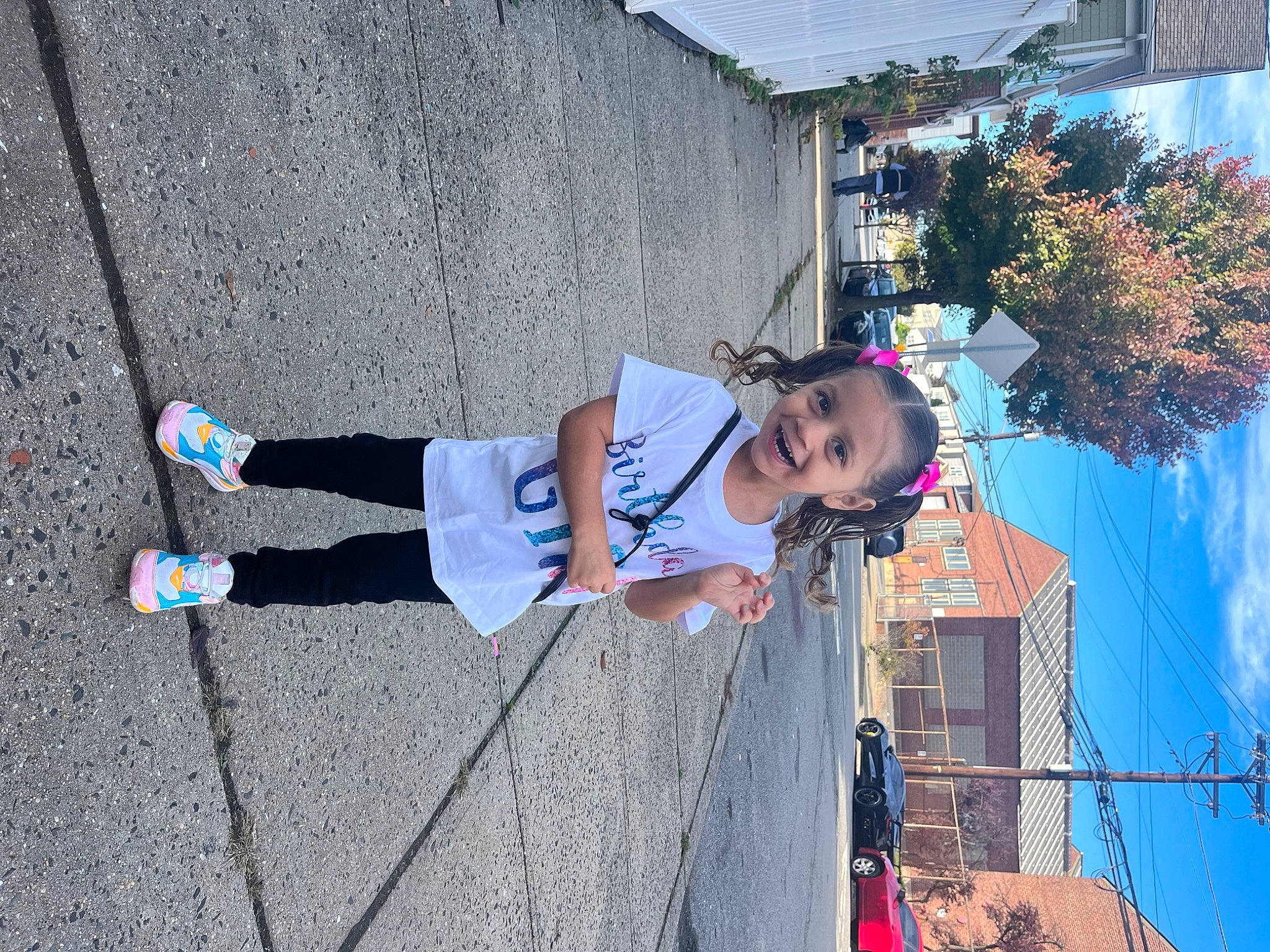 Hailey is registered to the contest to win money with this photo: asphalt, blue, building, child, city, electric_blue, facade, fun, joy, leisure, pedestrian, person, plant, recreation, road, shadow, sidewalk, sky, street, sunglasses