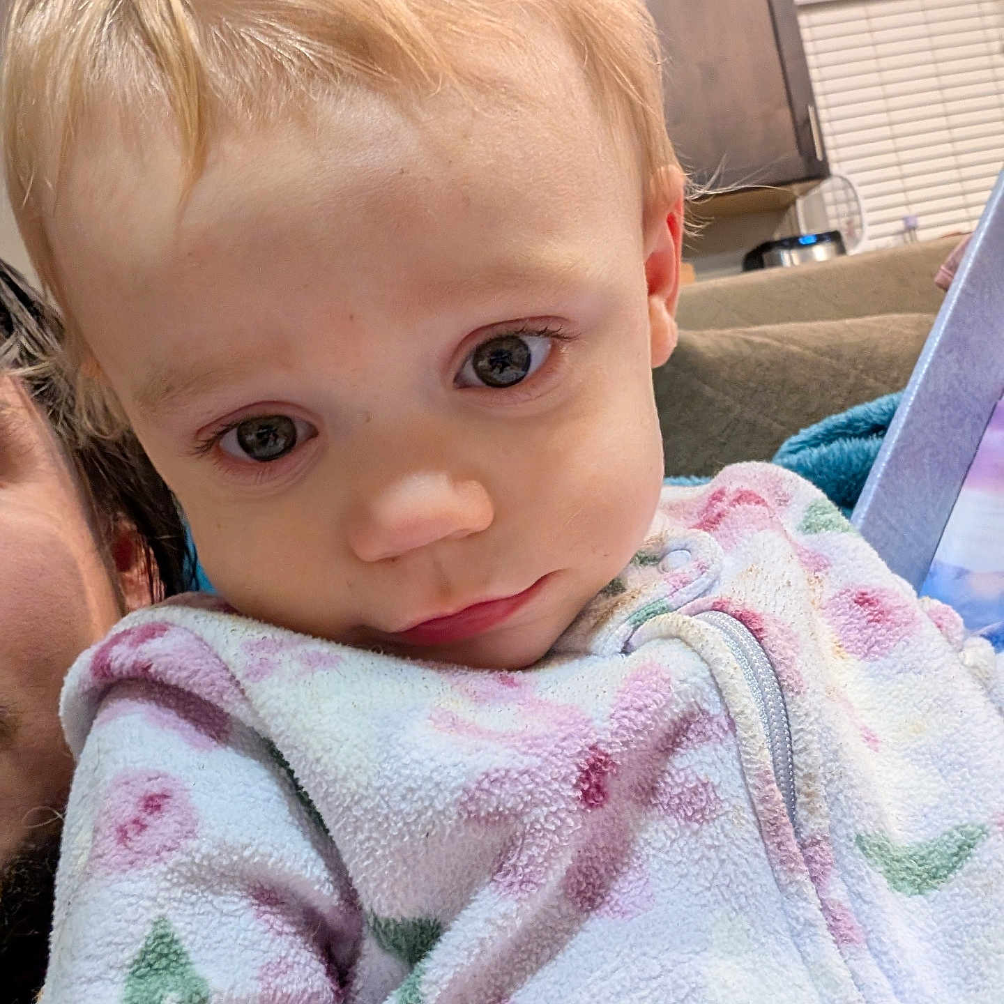 Maria is registered to the contest to win money with this photo: baby, blanket, blonde, computerhardware, couch, electronics, face, furniture, hair, hardware, head, indoors, monitor, person, photography, portrait, quilt, screen, towel, tv