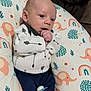 Zachary is registered to the contest to win money with this photo: baby, blue_eyes, boppy_pillow, clothing, cozy, elephant_pattern, fingers, hands, hedgehog_pattern, infant, newborn, nursery, onesie, pacifier, pillow, portrait, rainbow_pattern, sitting, skin, smile