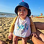 toddler, child, beach, sand, ocean, hat, bib, sunlight, shadow, water, people, summer, vacation, legs, hands, waves, sky, outdoor, daytime, casual