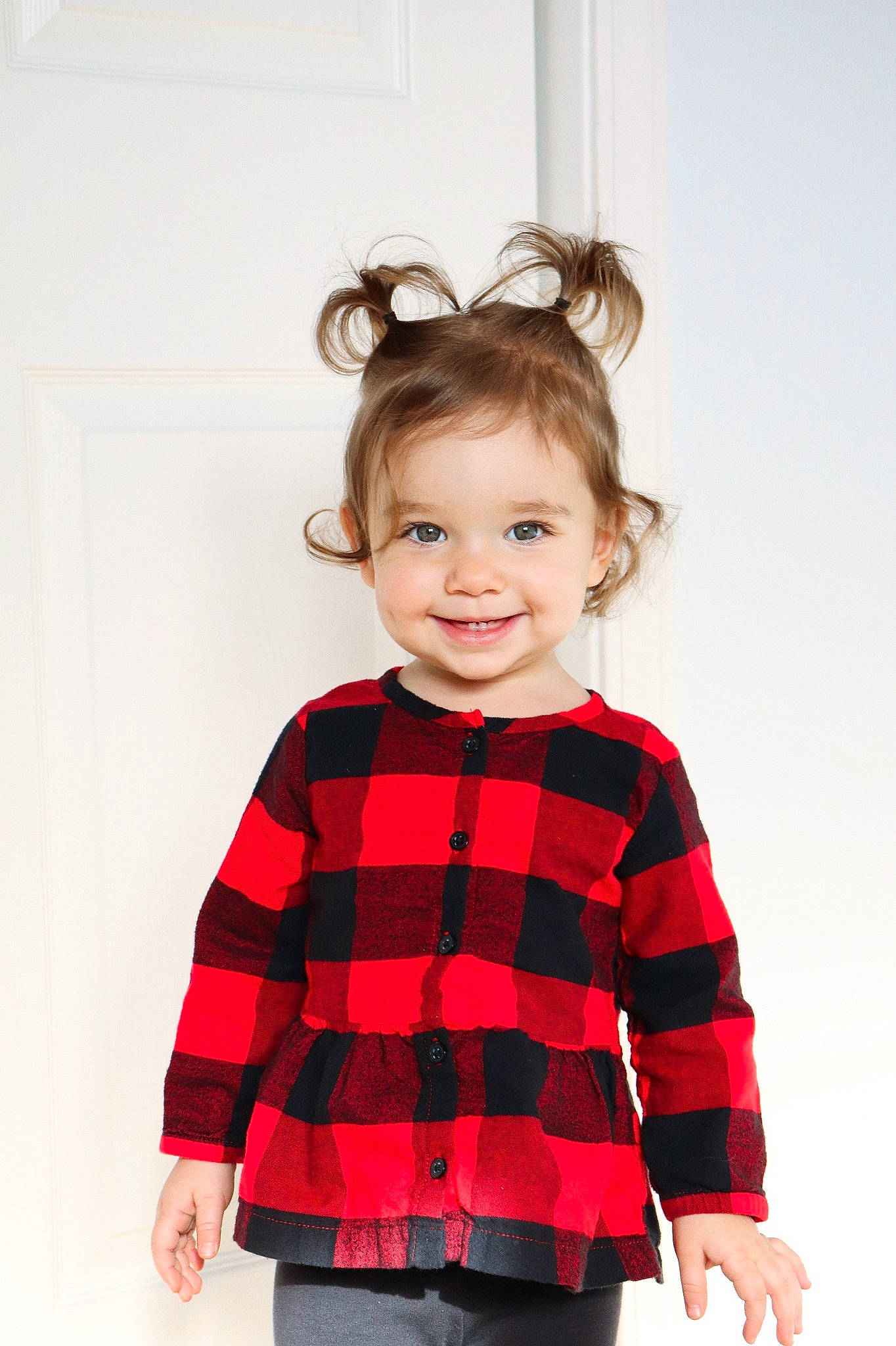 Tiffany is registered to the contest to win money with this photo: baby_toddler_clothing, child, child_model, clothing, denim, hairstyle, iris, jeans, joy, laugh, long_sleeved_t_shirt, mouth, pattern, person, plaid, shoulder, sleeve, standing, sweater, textile