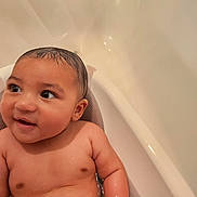 Damien joined the competition — help win amazing prizes! baby, bathtub, water, wet_hair, skin, child, infant, happy, smile, arm, shoulder, face, eyes, ear, bath, bathroom, sitting, cute, young, person