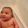 baby, bathtub, water, wet_hair, skin, child, infant, happy, smile, arm, shoulder, face, eyes, ear, bath, bathroom, sitting, cute, young, person