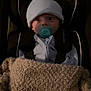 Enzo is registered to the contest to win money with this photo: baby, pacifier, blanket, car_seat, hat, infant, child, indoor, warm, cozy, seated, clothing, face, person, portrait, young, cute, comfort, sleepwear, resting