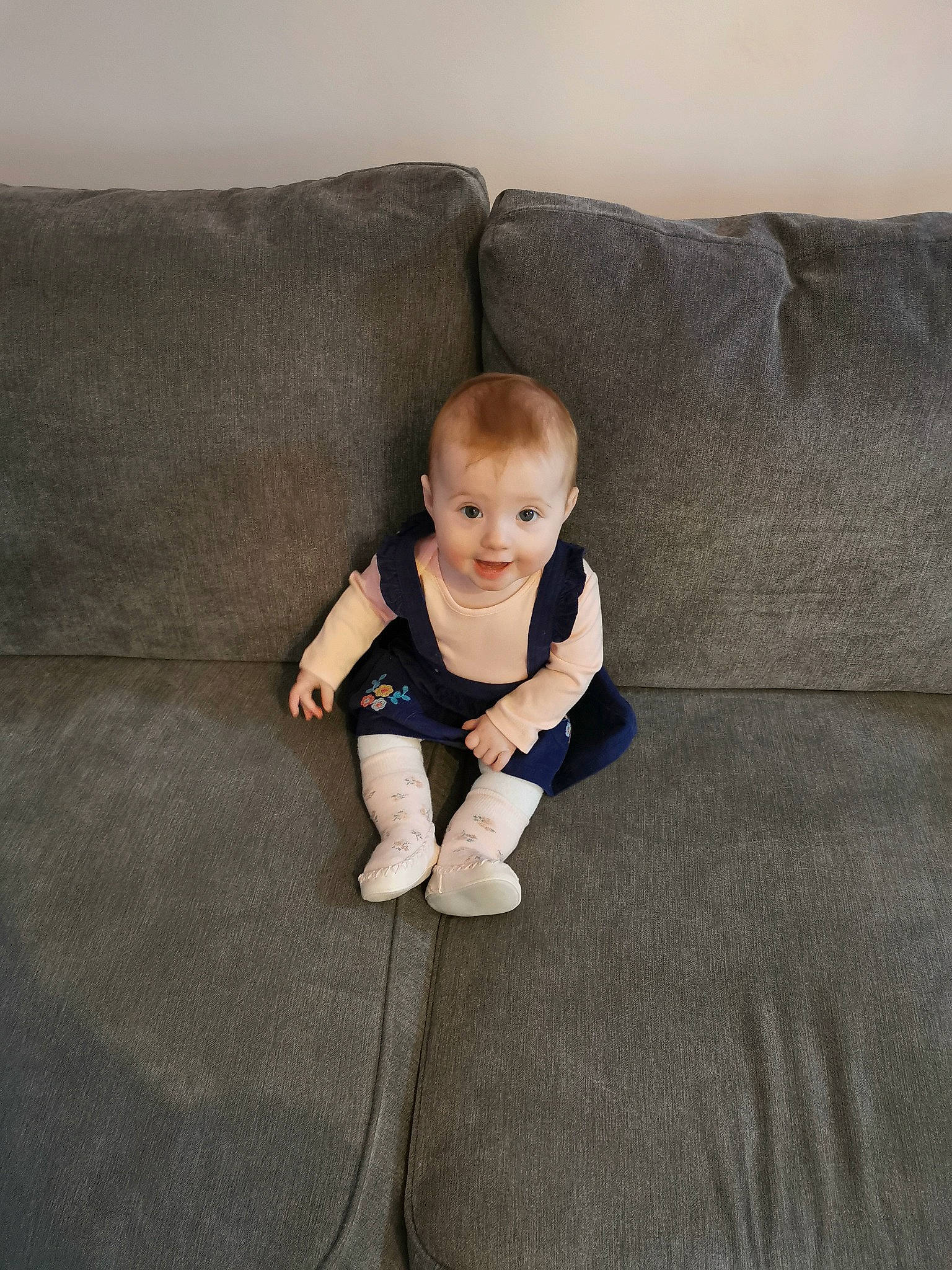 Marianna is registered to the contest to win money with this photo: baby, baby_toddler_clothing, comfort, couch, eye, face, flash_photography, floor, flooring, grey, hair, hardwood, head, human_body, joy, linens, person, sleeve, smile, t_shirt