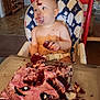 baby, cake, celebration, child, crumbs, cute, eating, face, food, frosting, funny, furniture, hands, high_chair, indoor, messy, person, red_velvet_cake, smudged, table