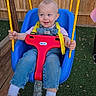 Vylette joined the competition — help win amazing prizes! toddler, child, swing, playground, outdoor, grass, wooden_fence, yellow_rope, blue_swing, red_swing_seat, overalls, pink_shirt, sneakers, happy, smiling, person, play, daylight, casual_clothing, fun