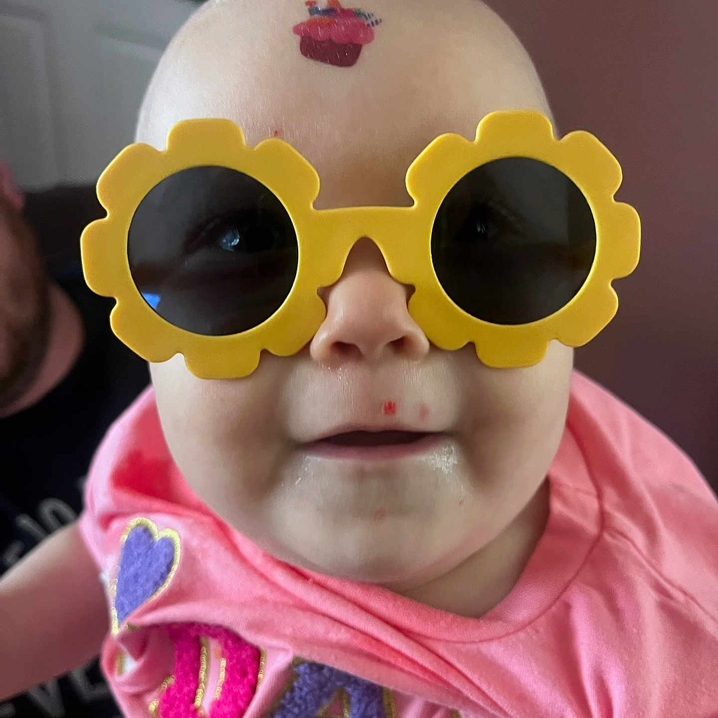 Vylette joined the competition — help win amazing prizes! accessory, baby, child, closeup, clothing, cupcake_sticker, cute, face, fashion, funny, glasses, head, indoor, infant, person, pink_shirt, portrait, smile, sunglasses, yellow