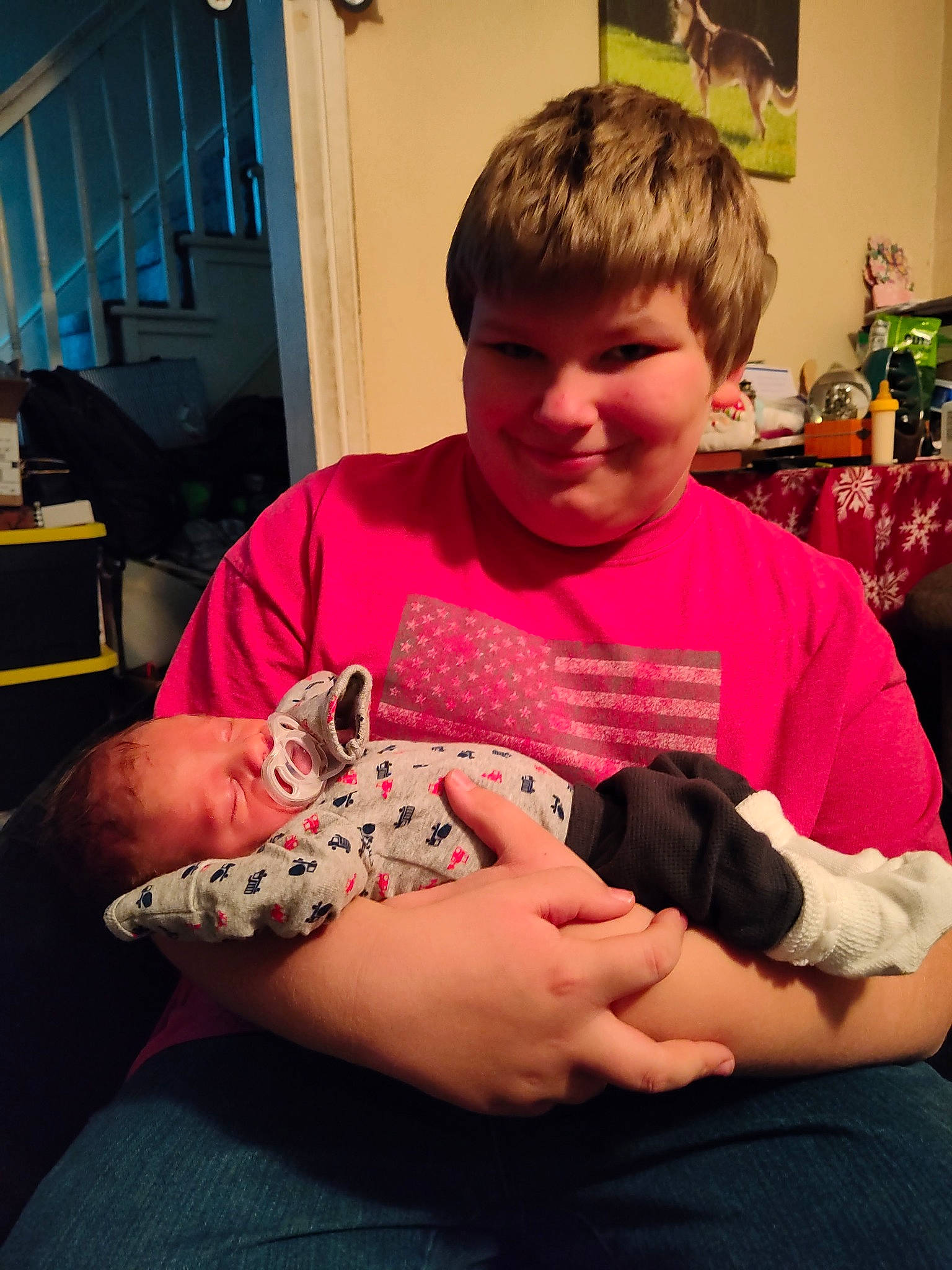 Killian is registered to the contest to win money with this photo: abdomen, baby, carnivore, child, comfort, companion_dog, dog_breed, elbow, felidae, finger, joy, knee, lap, person, shoulder, sitting, skin, smile, t_shirt, thumb