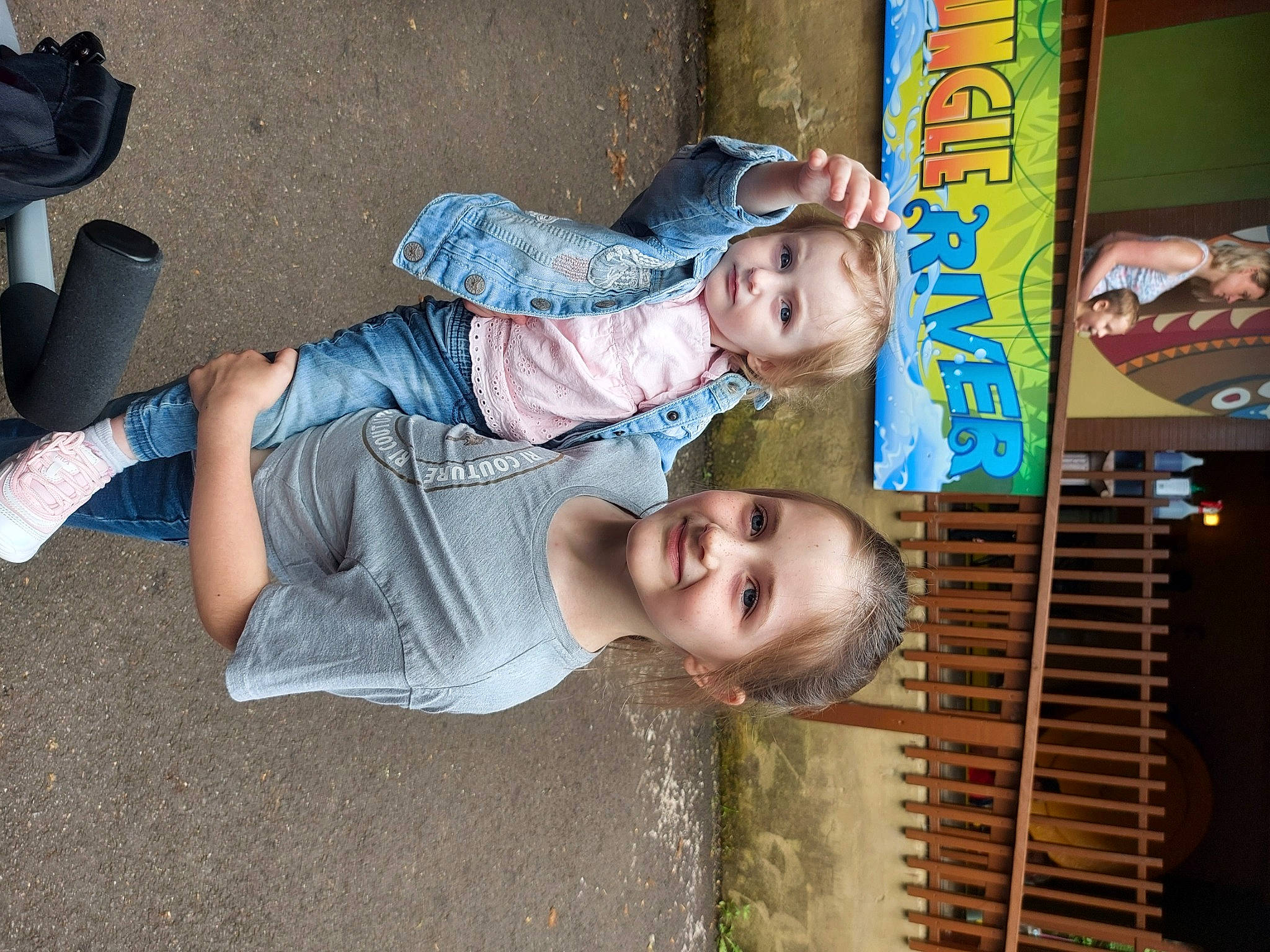 Isabelle is registered to the contest to win money with this photo: art, blurred, child, chin, cool, facial_expression, foot, fun, hairstyle, happy, human_leg, joy, leisure, mouth, person, public_space, sandal, smile, sock, t_shirt