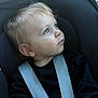 Robin participe au concours pour gagner de l'argent avec cette photo : baby, black_shirt, blond_hair, blue_eyes, car_seat, casual_clothing, child, close_up, curious, face, head, indoor, infant, looking_away, portrait, seatbelt, sitting, straps, toddler, young_child