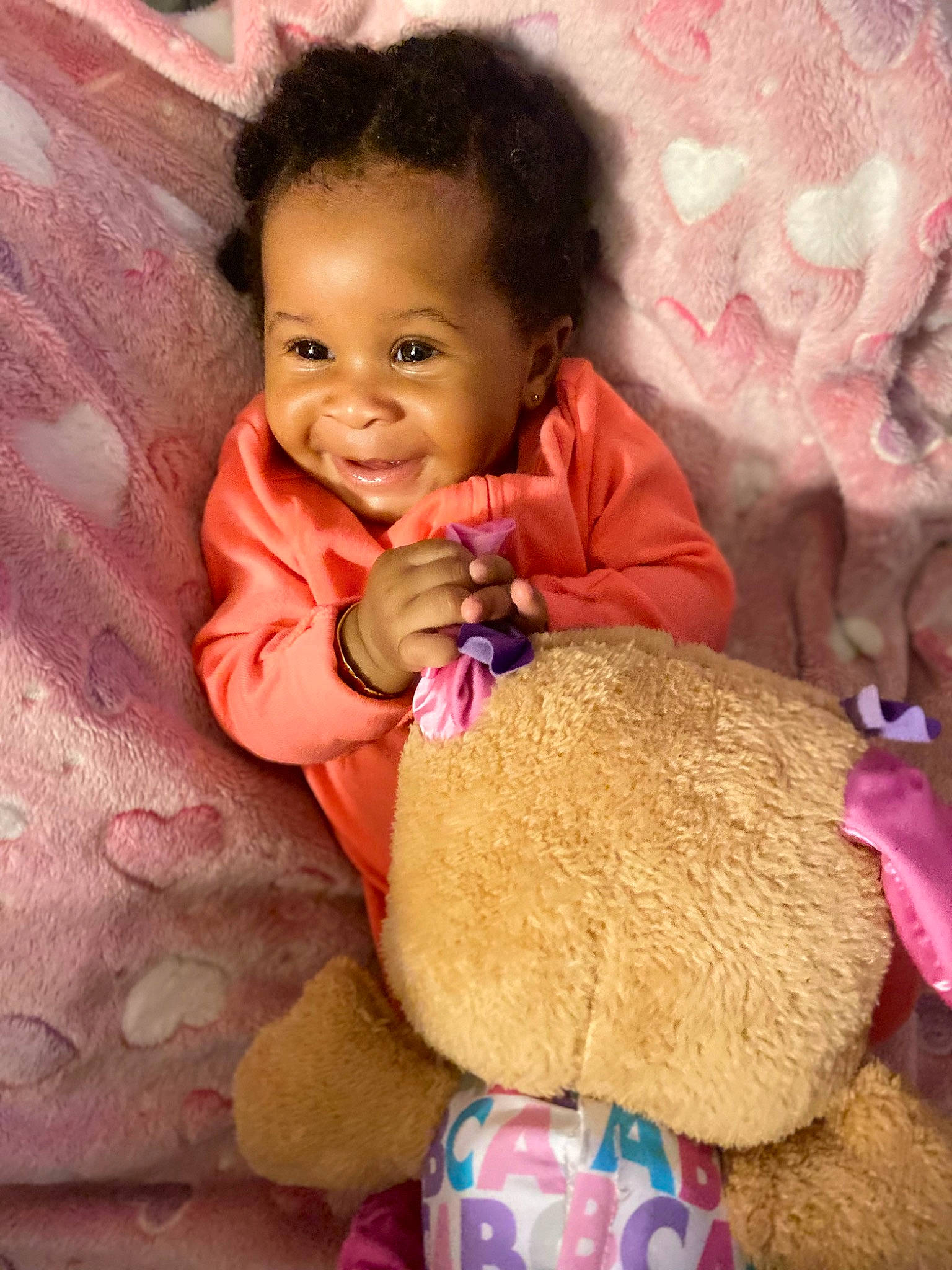 Jurnee joined the competition — help win amazing prizes! arm, baby, baby_toddler_clothing, cheek, child, dress, finger, hair, hand, happy, human_body, magenta, nose, organ, person, pink, skin, smile, teddy_bear, toddler