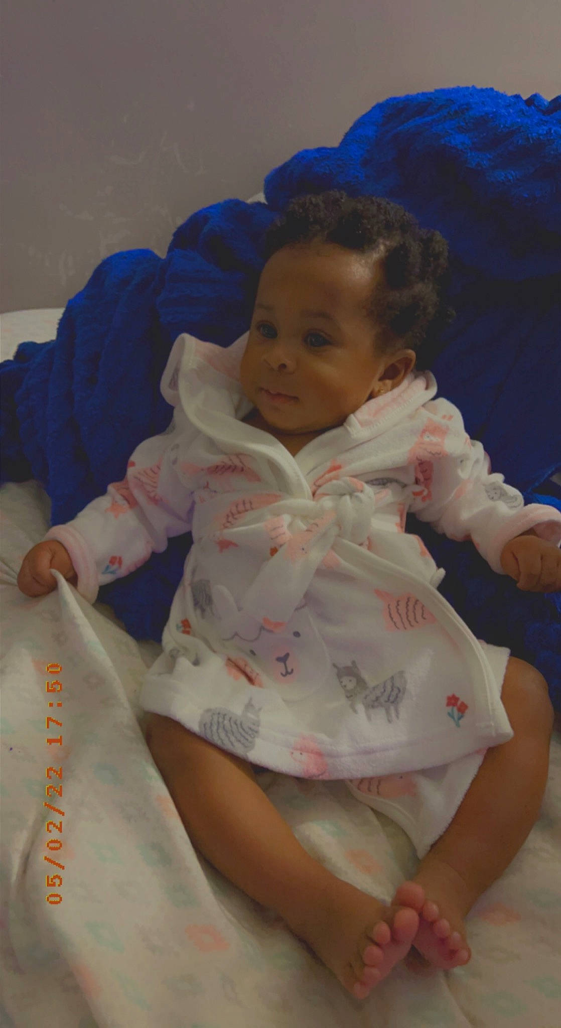 Jurnee joined the competition — help win amazing prizes! baby, baby_toddler_clothing, blue, child, comfort, finger, fun, gesture, happy, human_leg, leisure, linens, nose, pattern, person, play, sitting, skin, sleeve, thumb