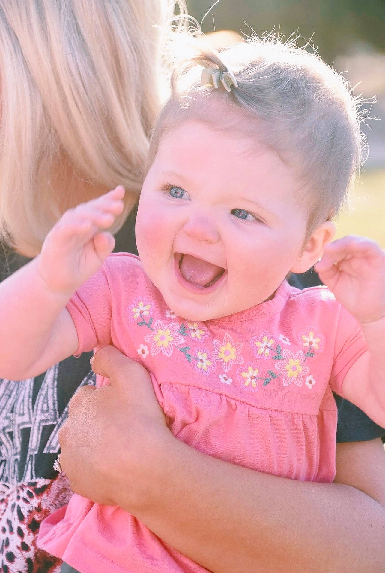 Macie is registered to the contest to win money with this photo: arm, baby, baby_toddler_clothing, blond, cheek, child, face, fun, gesture, grass, hand, happy, head, iris, jewellery, lip, person, pink, skin, smile