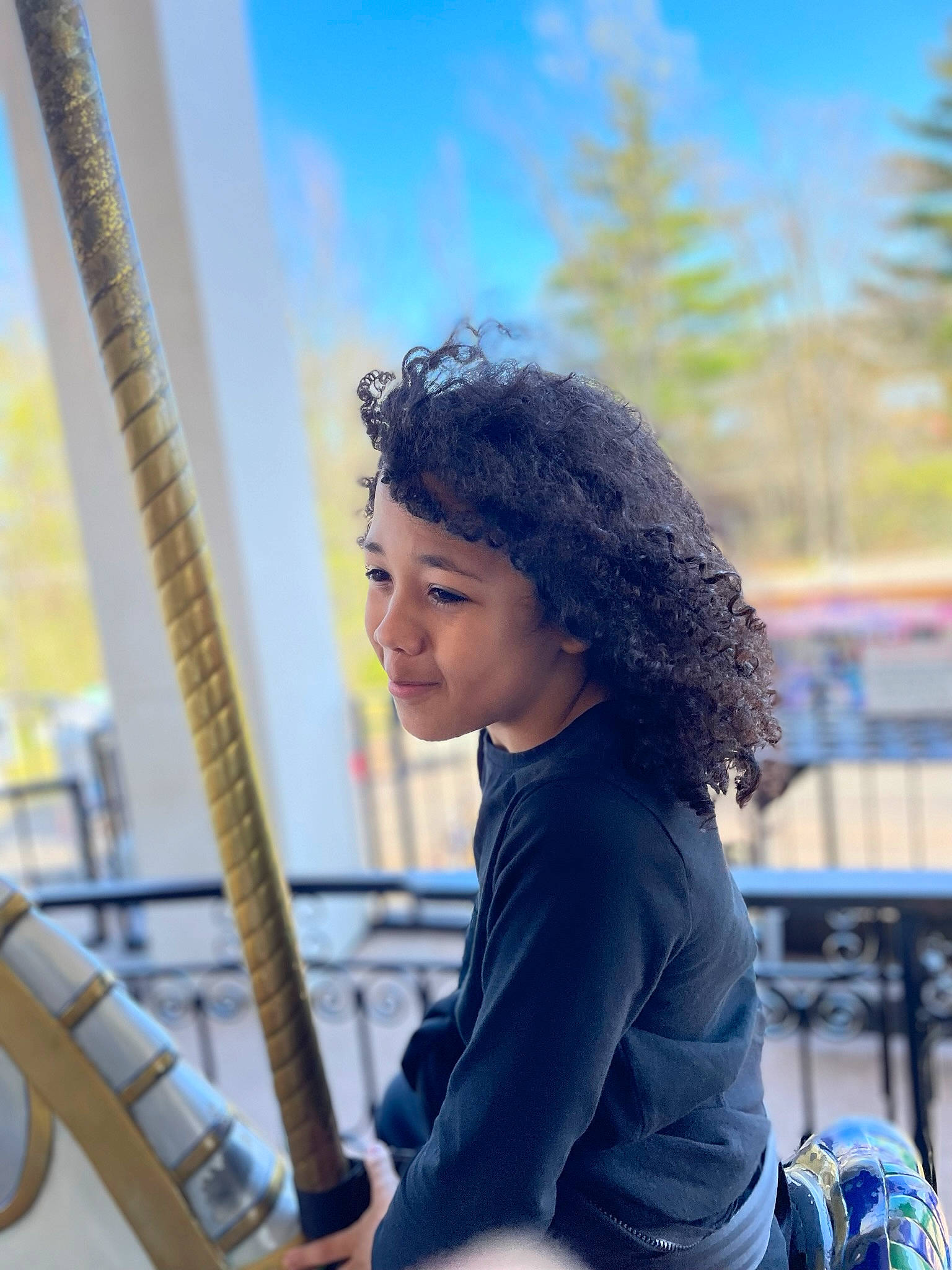 Apollo is registered to the contest to win money with this photo: azure, blue, child, electric_blue, fun, happy, joy, leisure, long_hair, musician, person, portrait_photography, recreation, sitting, sky, smile, standing, street, tourism, travel