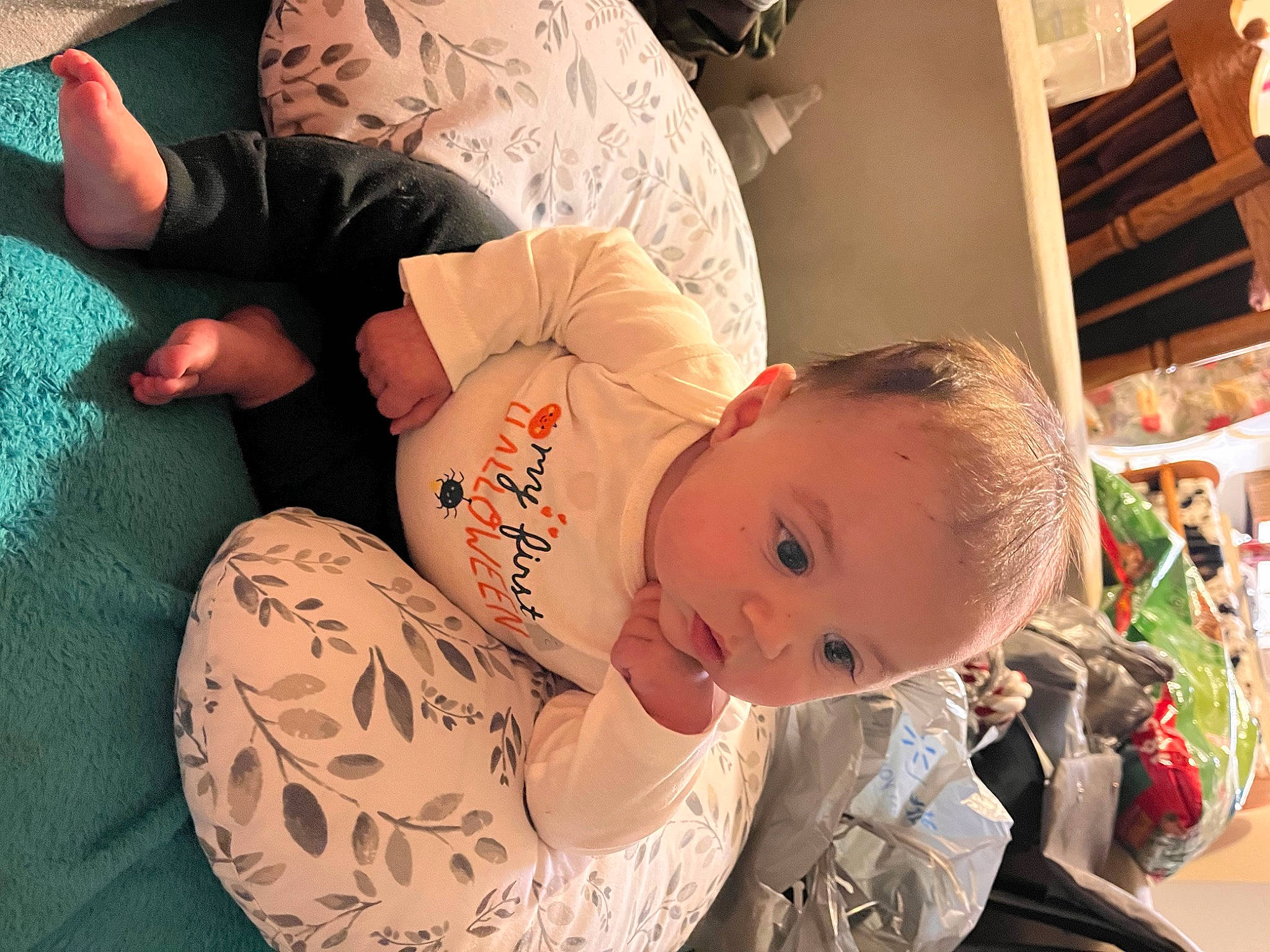 Camden is registered to the contest to win money with this photo: abdomen, baby, bedding, chest, child, comfort, elbow, flesh, happy, human_leg, knee, linens, mouth, nap, person, room, sitting, skin, thigh, toddler