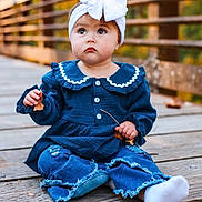 Oaklynn is registered to the contest to win money with this photo: toddler, child, baby, headband, bow, blue_clothing, jeans, ripped_jeans, wooden_bridge, leaf, autumn, outdoor, sitting, cute, portrait, fall, nature, curious, young_child, casual_clothing