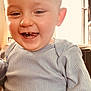 Stanislas participe au concours pour gagner de l'argent avec cette photo : baby, toddler, child, smiling, teeth, face, close_up, indoor, window, backlight, natural_light, sweater, ribbed_clothing, ear, portrait, happiness, cute, candid, skin, person