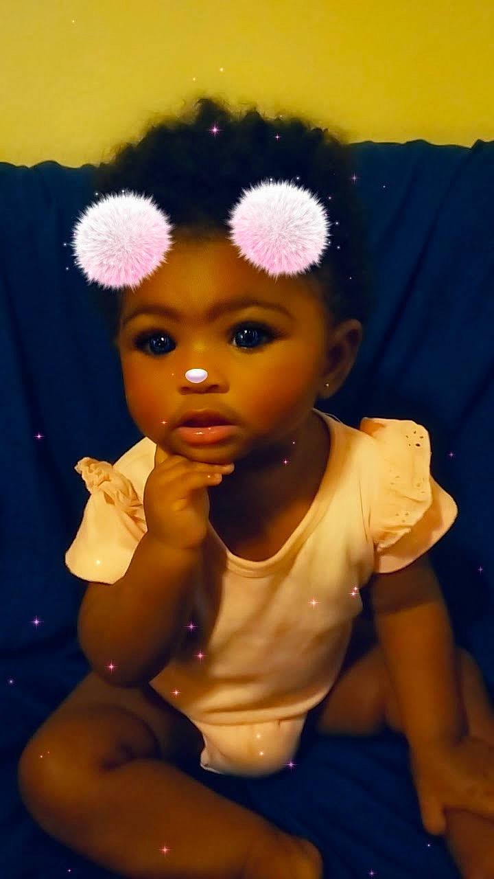 Annalise is registered to the contest to win money with this photo: afro, cheek, chin, doll, eye, eyebrow, eyelash, fawn, finger, forehead, hair, happy, head, headgear, headwear, iris, lip, nose, person, pink