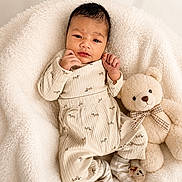 Lucas joined the competition — help win amazing prizes! baby, infant, teddy_bear, blanket, soft_texture, cute, cozy, pajamas, socks, smiling, child, plush_toy, comfort, portrait, resting, indoors, warm_colors, sleepwear, adorable, young