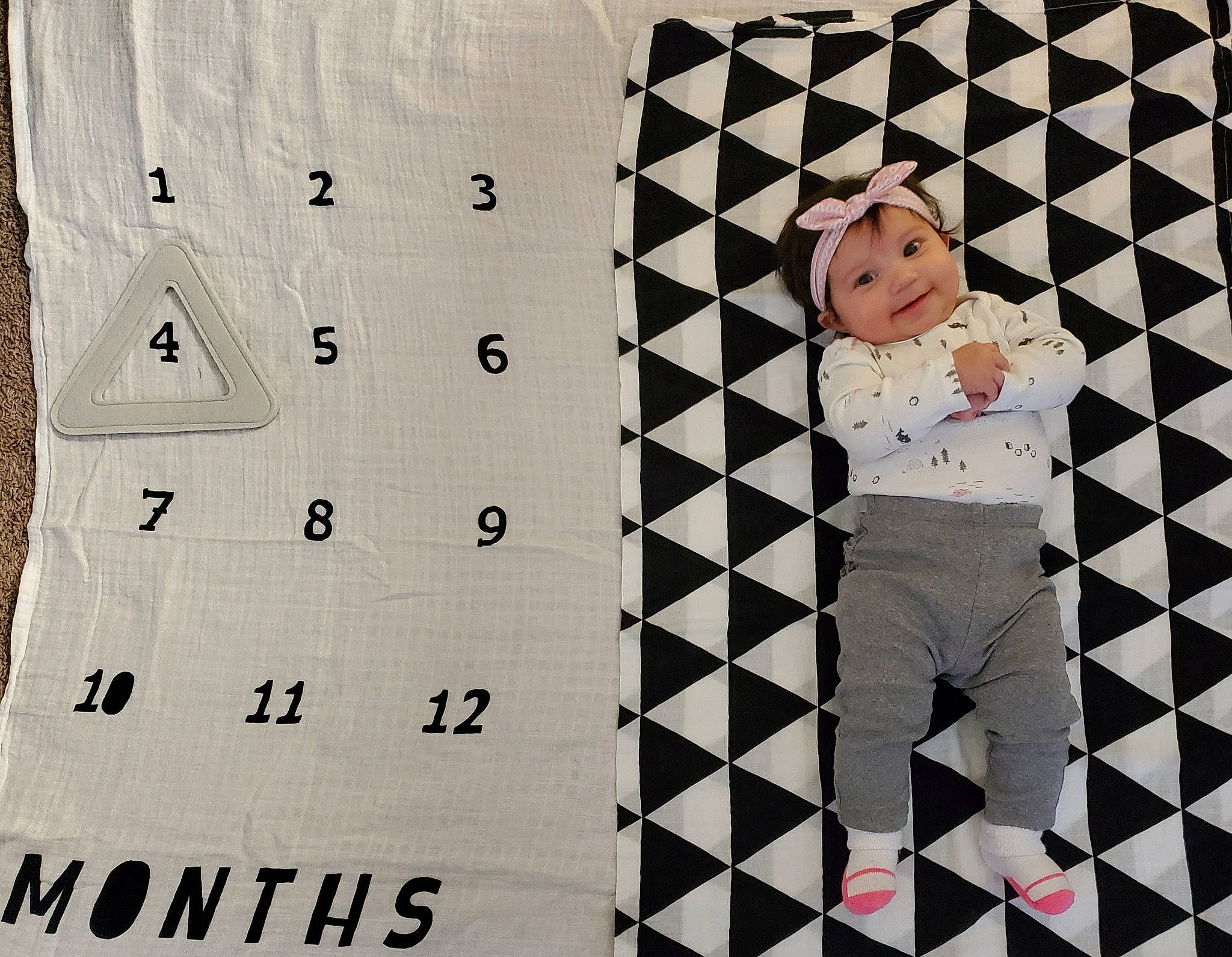 Briella is registered to the contest to win money with this photo: art, baby, baby_toddler_clothing, calendar, font, happy, headwear, joy, linens, monochrome_photography, number, paper, paper_product, pattern, person, rectangle, room, sleeve, square, style