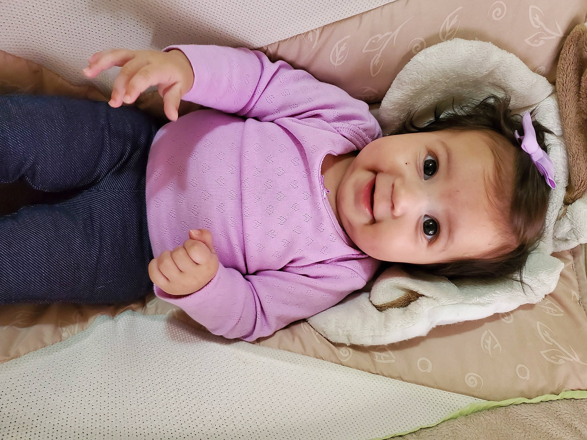Briella is registered to the contest to win money with this photo: baby, baby_toddler_clothing, cheek, comfort, eyelash, fur, human_body, linens, lip, magenta, nose, person, pink, purple, sitting, skin, sleeve, smile, textile, toddler