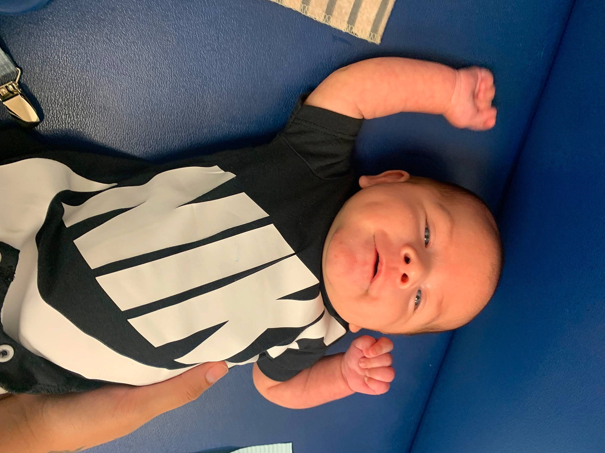 Ares is registered to the contest to win money with this photo: arm, baby, baby_products, baby_toddler_clothing, cheek, child, comfort, elbow, finger, gesture, hand, human_body, knee, lap, leg, person, sitting, sleeve, thigh, thumb