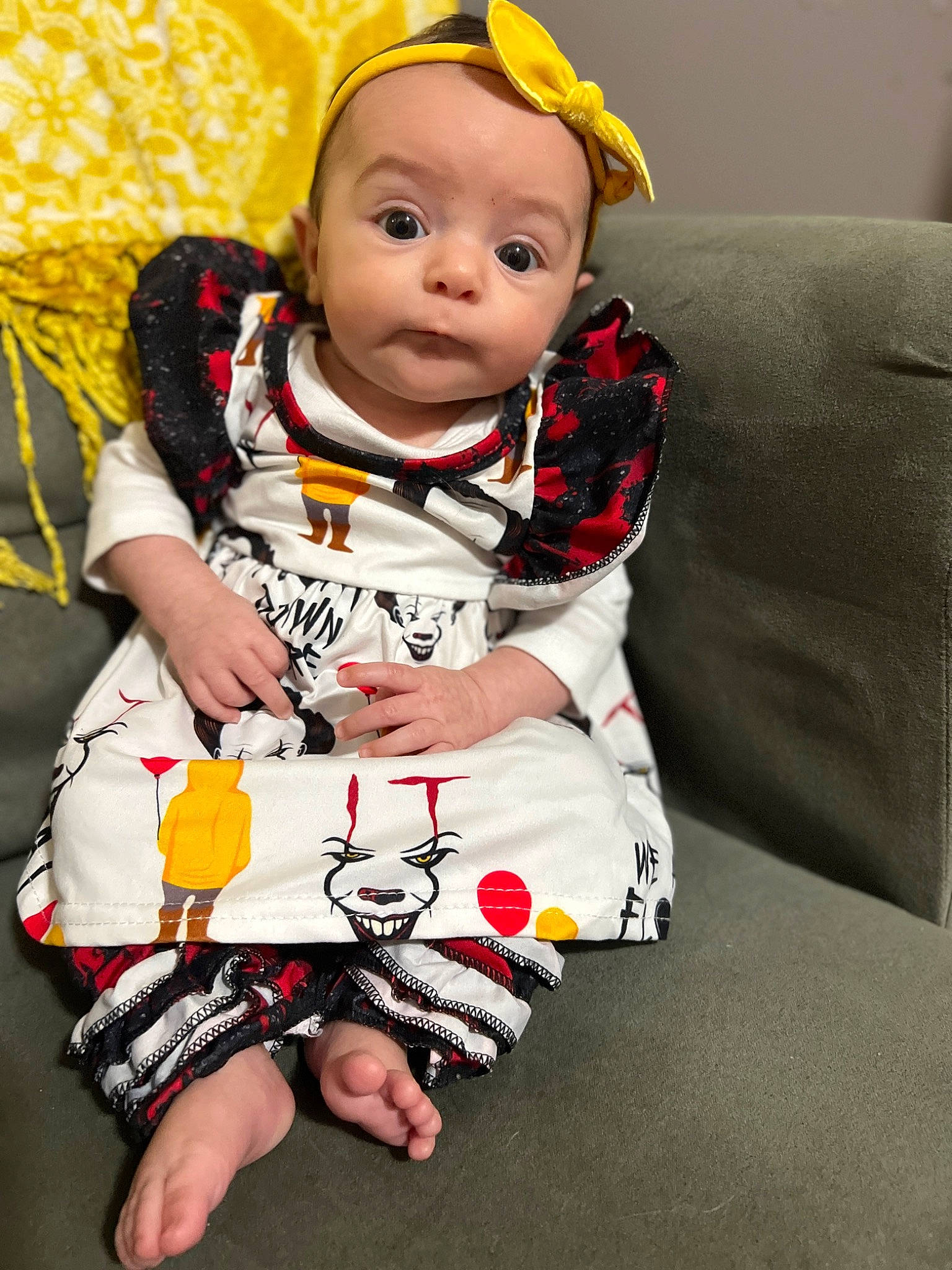 Penelope is registered to the contest to win money with this photo: baby, baby_toddler_clothing, cheek, child, comfort, couch, facial_expression, fun, happy, head, hoodie, pattern, person, portrait_photography, sitting, sleeve, smile, t_shirt, toddler