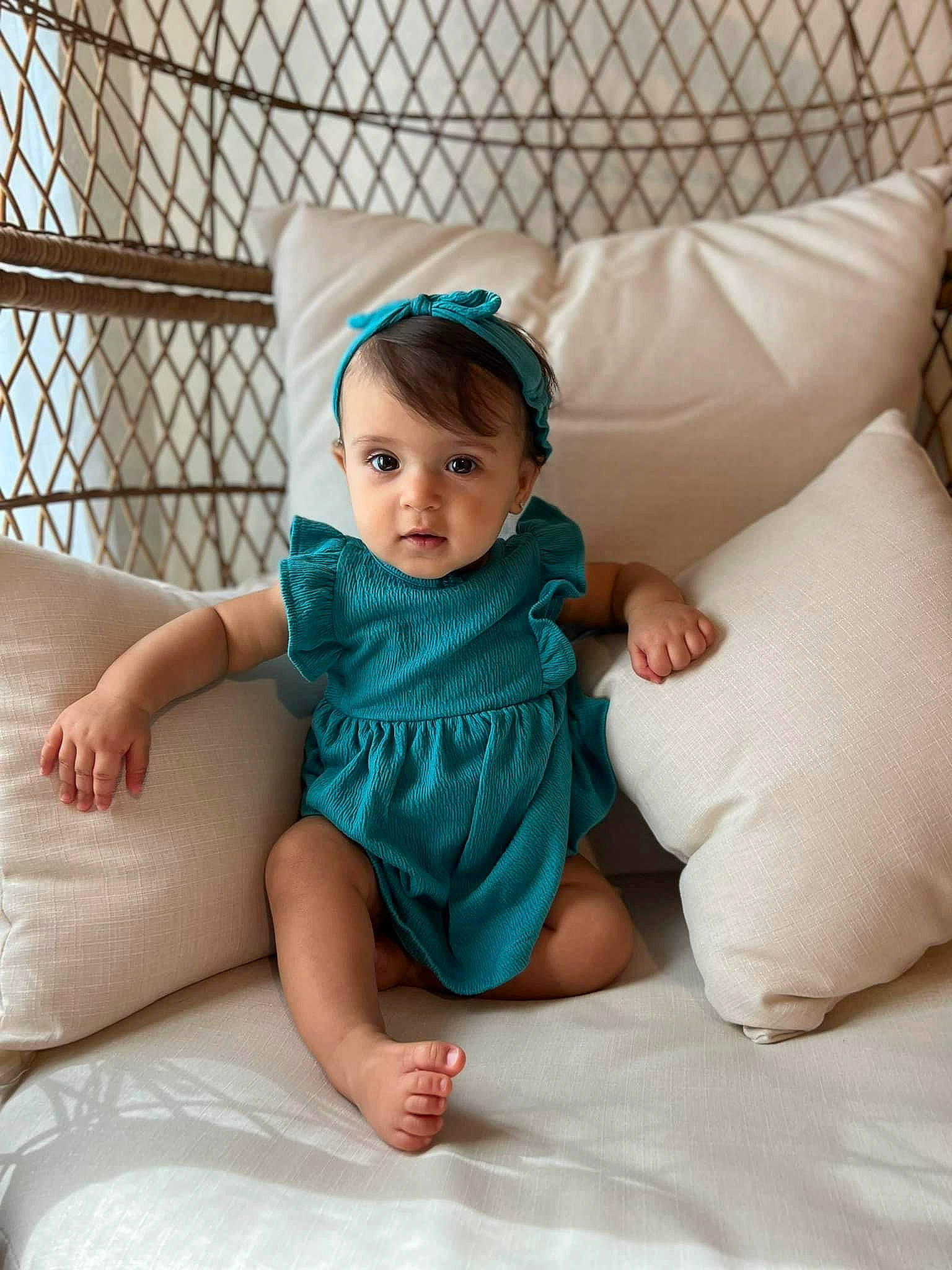 Nalani is registered to the contest to win money with this photo: arm, baby, baby_toddler_clothing, child, comfort, couch, dress, eye, face, finger, flash_photography, happy, head, iris, leg, linens, person, skin, sleeve, textile