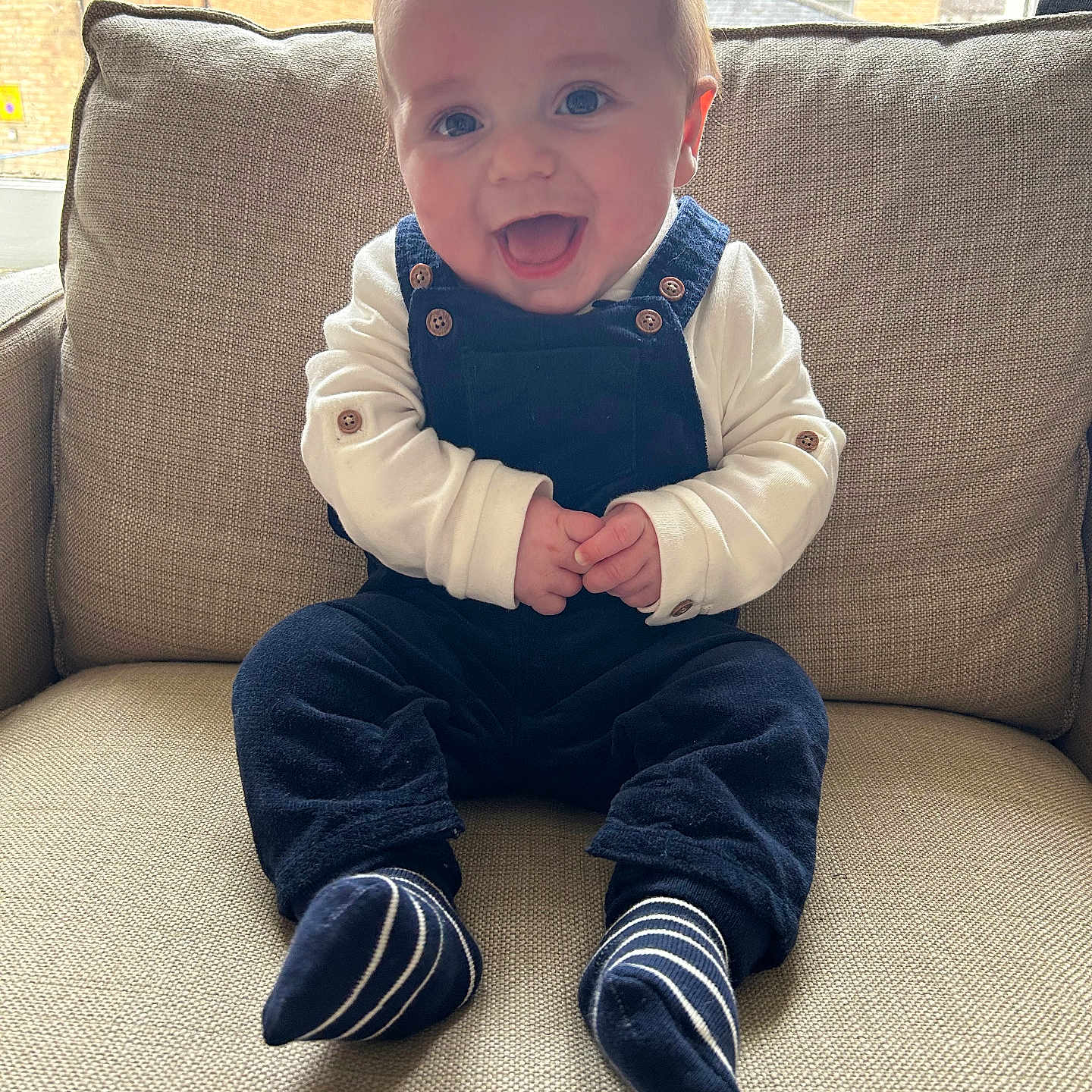 Arthur is registered to the contest to win money with this photo: accessories, architecture, baby, babylaughing, blazer, bodypart, building, chair, clothing, coat, couch, cushion, face, footwear, formalwear, furniture, happy, head, homedecor, hosiery