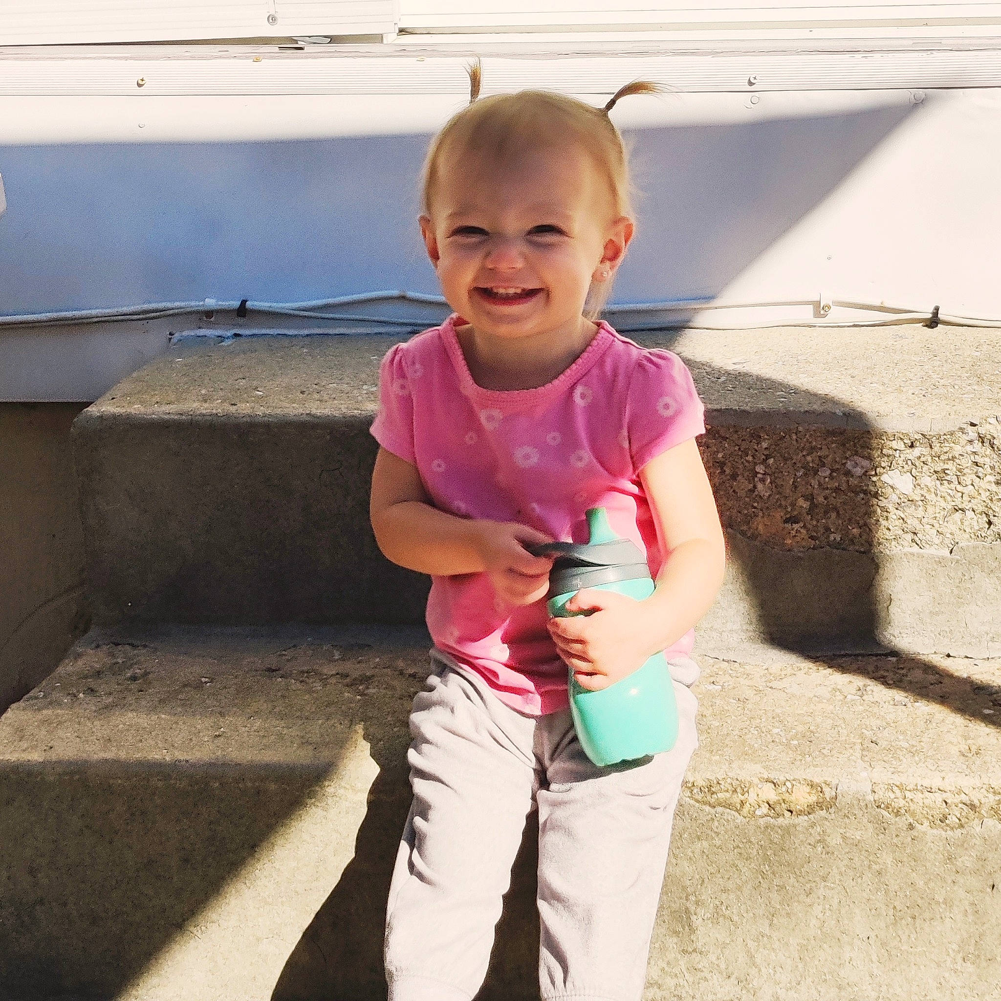 Lyncoln Journey is registered to the contest to win money with this photo: baby_toddler_clothing, fun, gesture, happy, human_leg, joy, leg, leisure, magenta, person, pink, skin, sleeve, smile, standing, street_fashion, t_shirt, thigh, thumb, toddler