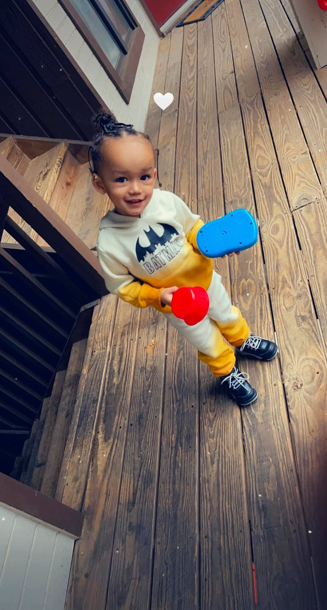 Khristian joined the competition — help win amazing prizes! baby_toddler_clothing, child, deck, electric_blue, flash_photography, floor, flooring, fun, happy, hardwood, human_leg, joy, leg, leisure, person, sitting, smile, sneakers, toddler, toy