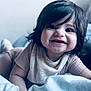 Ariella is registered to the contest to win money with this photo: baby, bed, blanket, child, clothing, cozy, cute, eyes, face, hair, happy, indoors, infant, lying_down, person, portrait, skin, smile, toddler, young