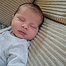 Nino participe au concours pour gagner de l'argent avec cette photo : baby, sleeping, cushion, beige, soft, texture, infant, face, peaceful, clothing, rest, comfort, portrait, indoor, cozy, child, young, person, closeup, peace