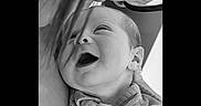 Nino participe au concours pour gagner de l'argent avec cette photo : baby, infant, smile, laugh, face, close_up, black_and_white, adult, glasses, emotion, joy, human, skin, clothing, portrait, tender_moment, love, expression, newborn, candid