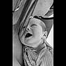 baby, infant, smile, laugh, face, close_up, black_and_white, adult, glasses, emotion, joy, human, skin, clothing, portrait, tender_moment, love, expression, newborn, candid