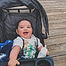 baby, stroller, blanket, bottle, smiling, happy, child, outdoor, boardwalk, wood, person, clothing, babytrend, blue, cute, infant, face, hand, toddler, daytime