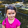 blue_eyes, braids, casual, child, fence, girl, greenery, happy, nature, outdoor, pink_shirt, pond, portrait, rocks, sequin, smile, star, sunlight, water, wooden_path