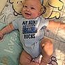 Luca is registered to the contest to win money with this photo: baby, child, smiling, onesie, text_on_clothing, lying_down, quilt, winnie_the_pooh, plush, cute, happy, infant, arm, leg, head, face, blue_clothing, soft_toys, indoor, person