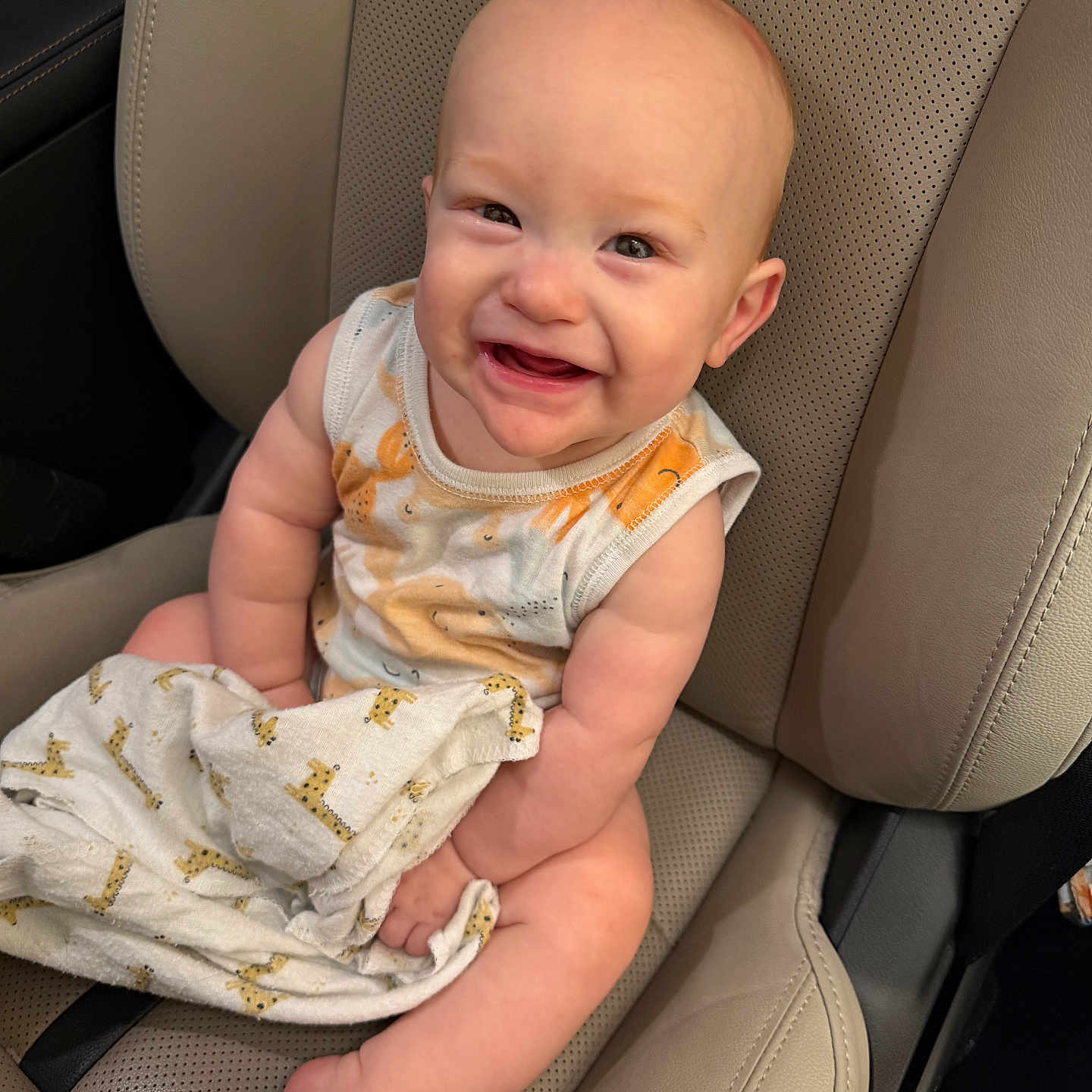 Luca joined the competition — help win amazing prizes! baby, child, smiling, car_seat, seat, blanket, giraffe_pattern, clothing, sleeveless, cute, happy, infant, person, skin, head, face, arm, leg, indoor, transportation