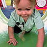 toddler, child, playground, slide, crawling, mickey_mouse, shirt, green, outdoor, play_equipment, musical_notes, happy, cute, face, hands, fun, summer, daylight, park, person