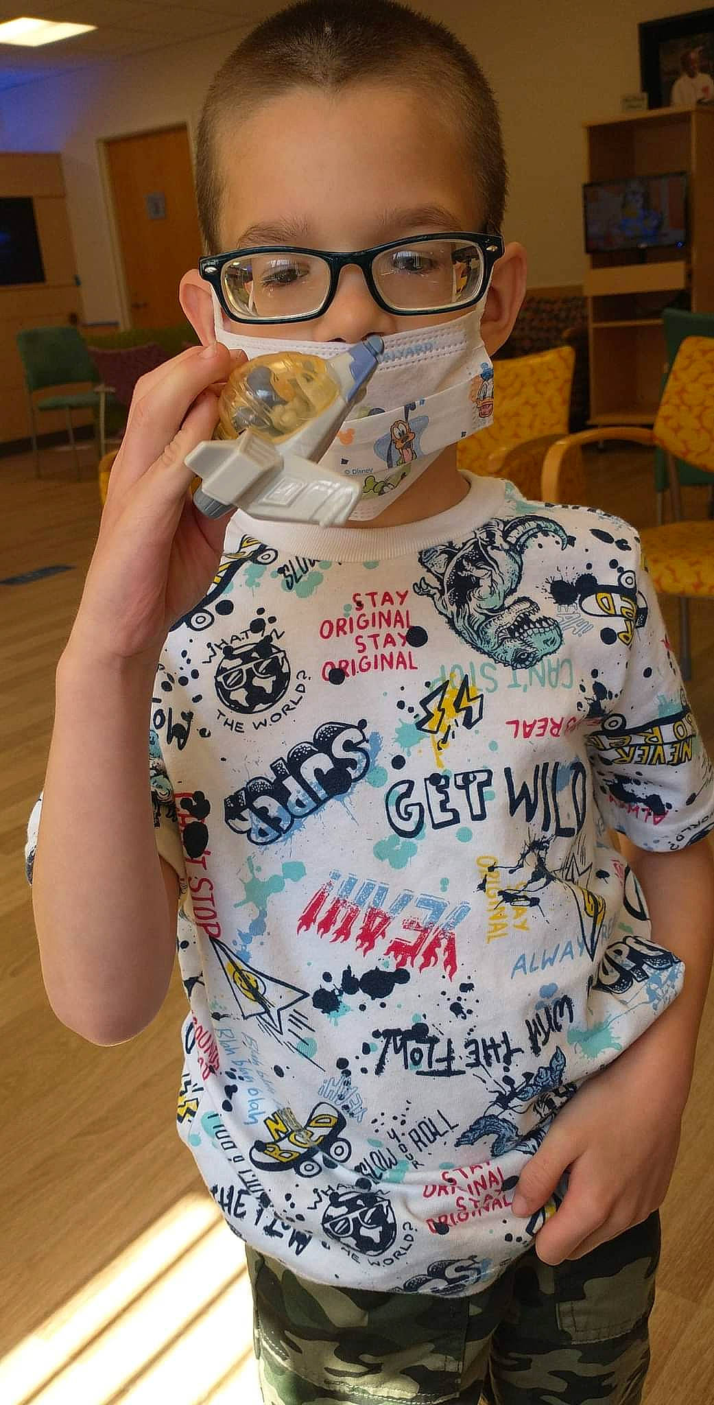 Aaron joined the competition — help win amazing prizes! chair, chest, child, chin, cool, eyelash, eyewear, finger, forehead, fun, gesture, glasses, mouth, neck, person, personal_protective_equipment, sleeve, t_shirt, vision_care, visual_arts