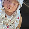 baby, newborn, sleeping, infant, portrait, face, hat, knit_hat, winter_clothing, onesie, car, vehicle, indoors, peaceful, closed_eyes, child, fluffy, cozy, festive, photography