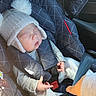 newborn, baby, sleeping, car_seat, infant, winter_hat, pom_pom, blanket, clothing, gray, white, portrait, vehicle, safety_harness, seatbelt, cozy, peaceful, indoors, travel, family