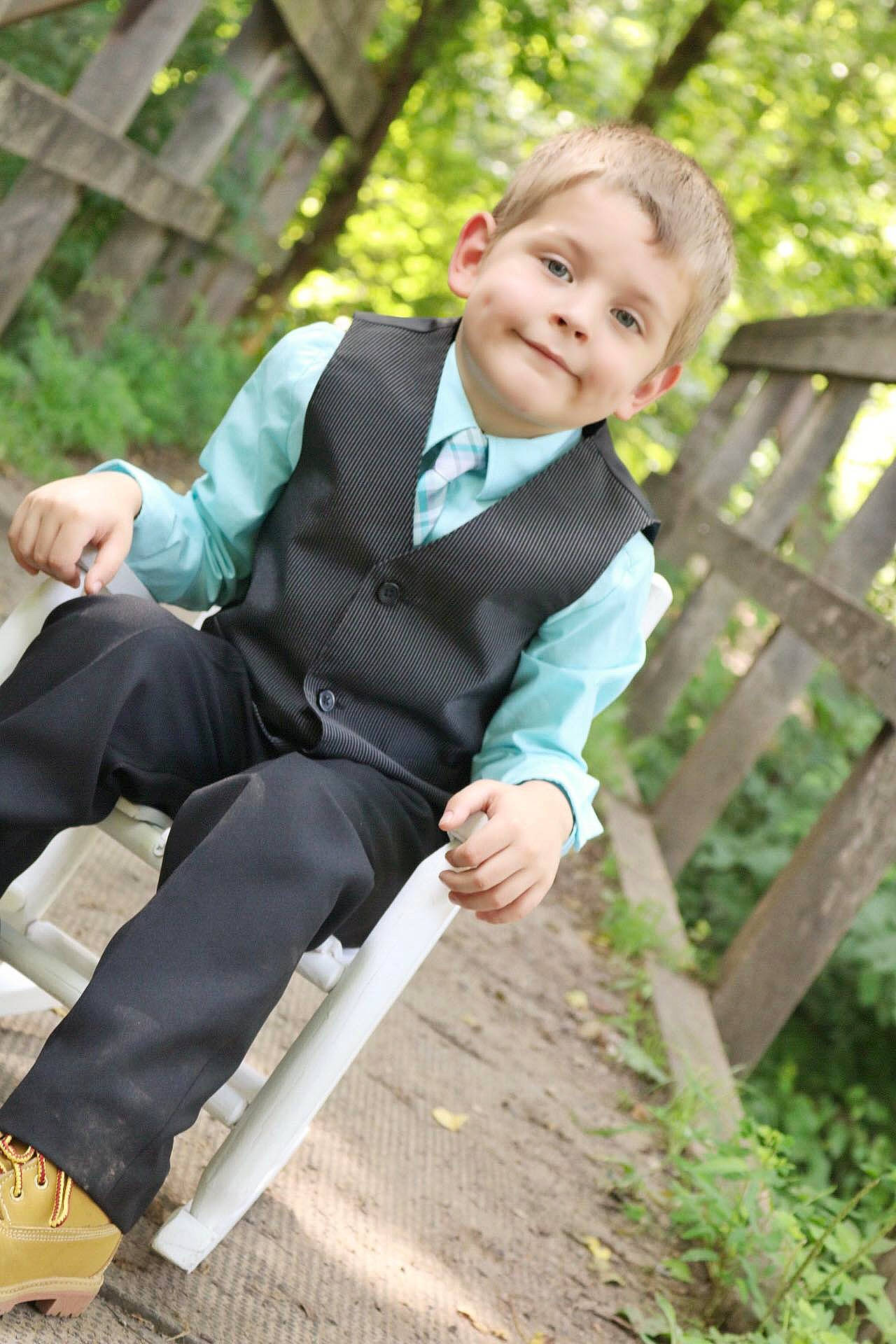 Phoenix is registered to the contest to win money with this photo: child, child_model, formal_wear, jacket, male, outerwear, person, photograph, photography, sitting, smile, suit, tie, toddler, tuxedo