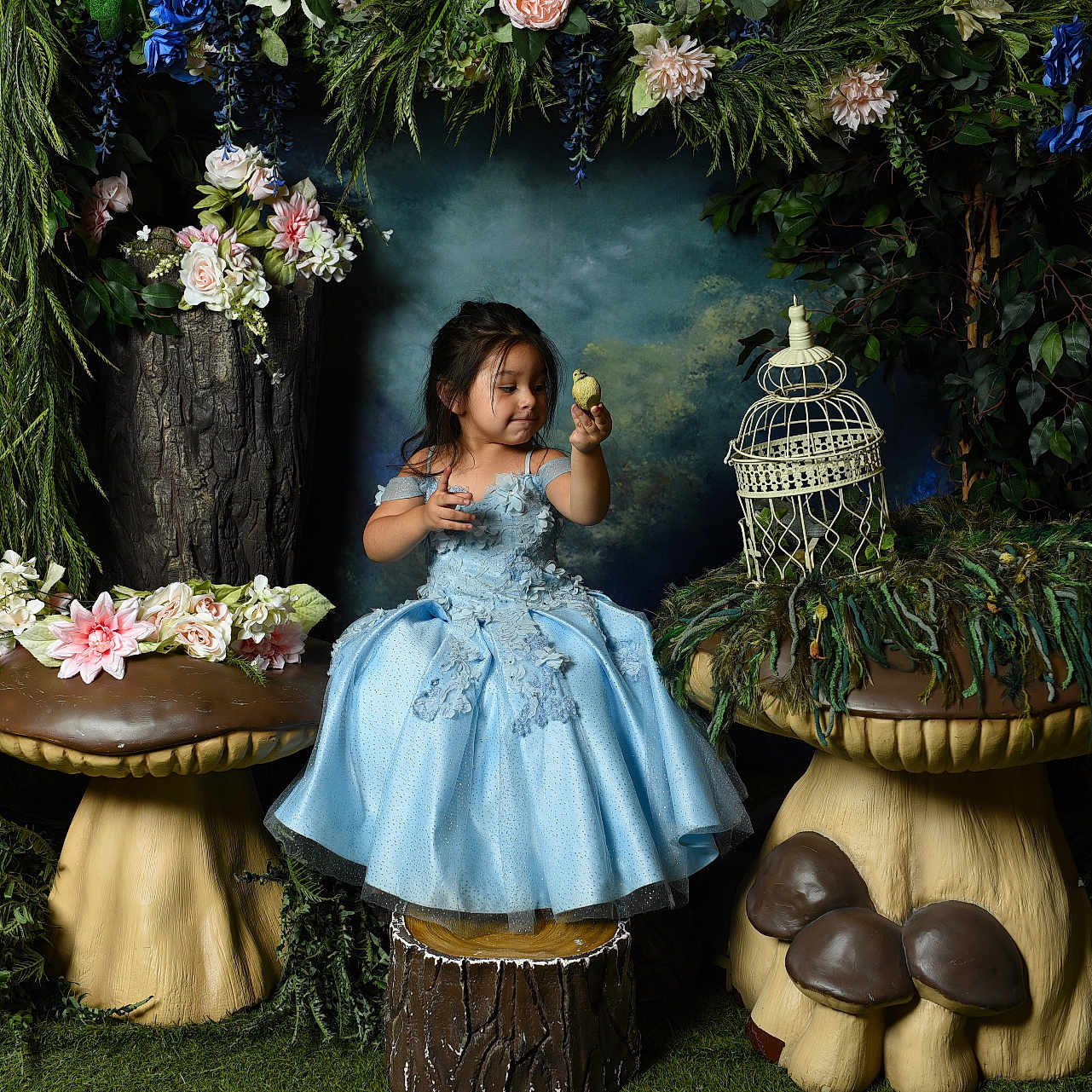 Lucia is registered to the contest to win money with this photo: child, girl, blue_dress, mushroom, flowers, greenery, nature, fantasy, portrait, indoor, decor, plant, tree_stump, smile, playful, cute, dress, sitting, whimsical, fairy_tale