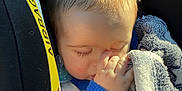 Tyler a rejoint le concours — aidez-le/la à gagner de superbes lots ! baby, child, car_seat, blanket, thumb_sucking, sleeping, sunlight, blue_clothing, face, hair, infant, peaceful, comfort, soft_texture, closeup, person, indoor, nap, rest, cute
