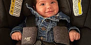 Araceli is registered to the contest to win money with this photo: baby, car_seat, denim_jacket, smile, child, straps, purple_bow, infant, clothing, seatbelt, cute, happy, indoors, safety, toddler, face, person, striped_pants, button, headwear
