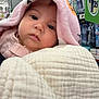 Araceli is registered to the contest to win money with this photo: baby, blanket, face, infant, child, portrait, closeup, soft_texture, quilt, pink, white, shopping_aisle, store, toothbrush, product_shelf, curious, cozy, clothing, indoors, person