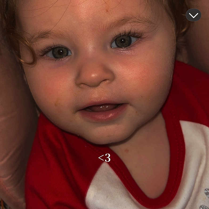 Sheryl participe au concours pour gagner de l'argent avec cette photo : baby, child, closeup, curly_hair, cute, expression, eyes, face, holiday_theme, indoors, infant, mouth, nose, person, portrait, red_clothing, skin, smile, toddler, white_clothing